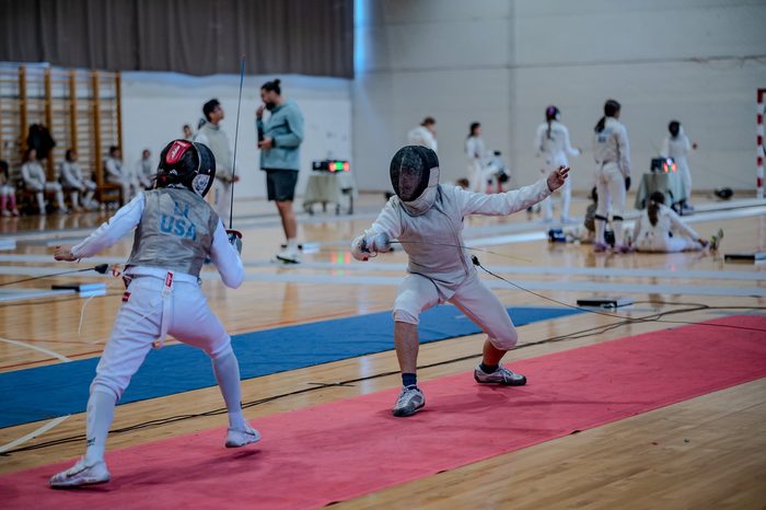 Two fencers bouting on the piste