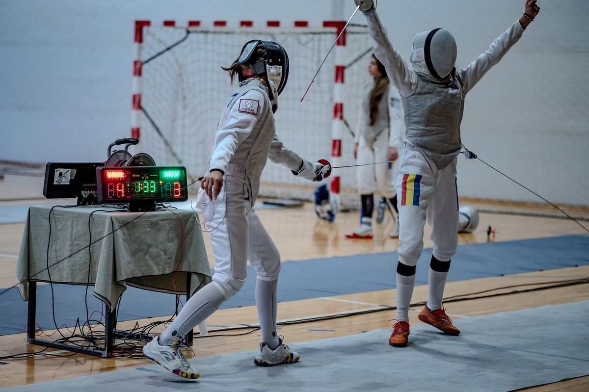 Fencers celebrating a touch during the camp
